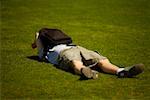 Man lying on the grass, New York City, New York State, USA
