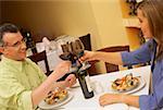 Close-up of a mid adult couple toasting glasses of wine