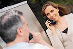 Close-up of a mid adult couple talking on a pay phone