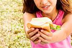 Close-up of a girl holding a hamburger