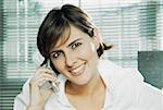 Portrait of a mid adult woman talking on a mobile phone and smiling