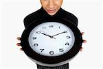 Close-up of a businesswoman holding a clock