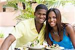 Portrait of a young man and a teenage girl sitting in a restaurant