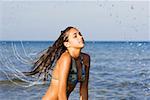 Close-up of a young woman with her eyes closed in the sea