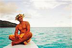 Close-up of a young man sitting on a ship's bow, Hawaii, USA