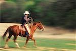 Side profile of a cowboy riding a horse, Texas, USA