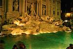 Statues at a fountain lit up at night, Trevi Fountain, Rome, Italy