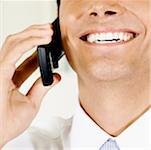 Close-up of a businessman talking on a mobile phone and smiling