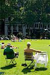 Group of people sunbathing in a park