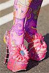 Close-up of a person's painted legs in high heels