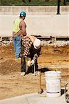 Two construction workers working at a construction site