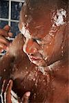 Close-up of a young man having a bath