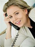 Portrait of a mid adult woman talking on the telephone and smiling