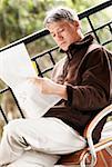 Side profile of a senior man reading a newspaper