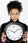 Portrait of a businesswoman holding a clock