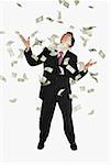 American dollar bills raining down on a businessman