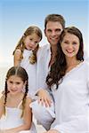 Portrait of a young couple and their two daughters smiling