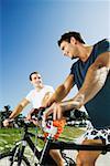 Low angle view of two young men on bicycles