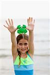 Close-up of a girl holding a toy on the beach