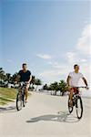 Two young men cycling on the road