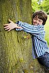 Boy Hugging Tree