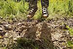 Child Jumping in Mud