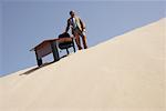 Businessman by Desk on Sand Dune