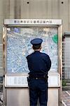 Polieman Looking at Map, Tokyo, Japan