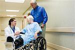 Doctor Speaking with Elderly Couple in Hospital