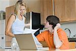 Couple in Kitchen with Laptop Computer