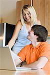 Couple in Kitchen with Laptop Computer