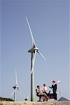 Business People around Desk at Wind Farm