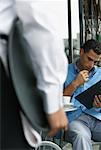 Man Reading Menu at Cafe