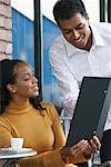 Woman Talking to Waiter at Cafe