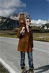 Woman Carrying Guitar on Road, Abruzzi, Italy