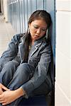 Student Sitting in School Hallway