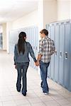Couple Walking in School Hallway