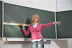 Teacher Standing at Blackboard Calling on Student