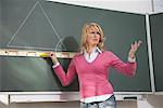 Teacher Standing at Blackboard Showing Annoyance with Class