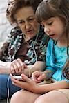 Grandmother and Granddaughter With MP3 Player