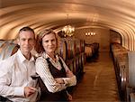 Couple Standing in Wine Cellar