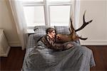 Hunter Sleeping with Deer Head