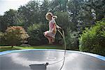 Girl Jumping Rope on Trampoline