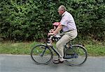 Grandfather Bicycling with Granddaughter, Denmark