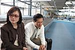 Couple Waiting for Luggage, Vancouver, British Columbia, Canada