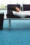 Man Sleeping in Airport Waiting Area