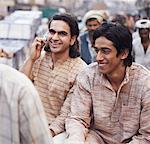 Two young men sitting in a rickshaw