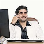 Close-up of a businessman talking on a cordless phone