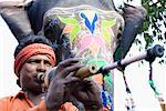 Low angle view of a young man playing a wind instrument, Jaipur Rajasthan, India