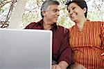 Low angle view of a mature couple sitting in front of a laptop